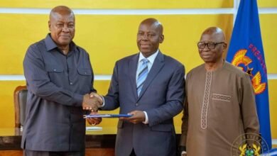 • President Mahama (left) receiving the report from Professor Lawso