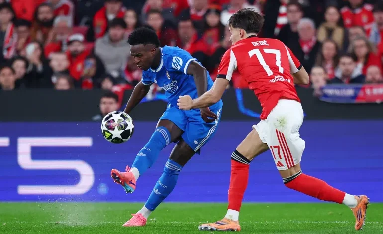 Vini Jr unleashes a pearler of a curler past Benfica’s Amar Dedic to put the visitors ahead