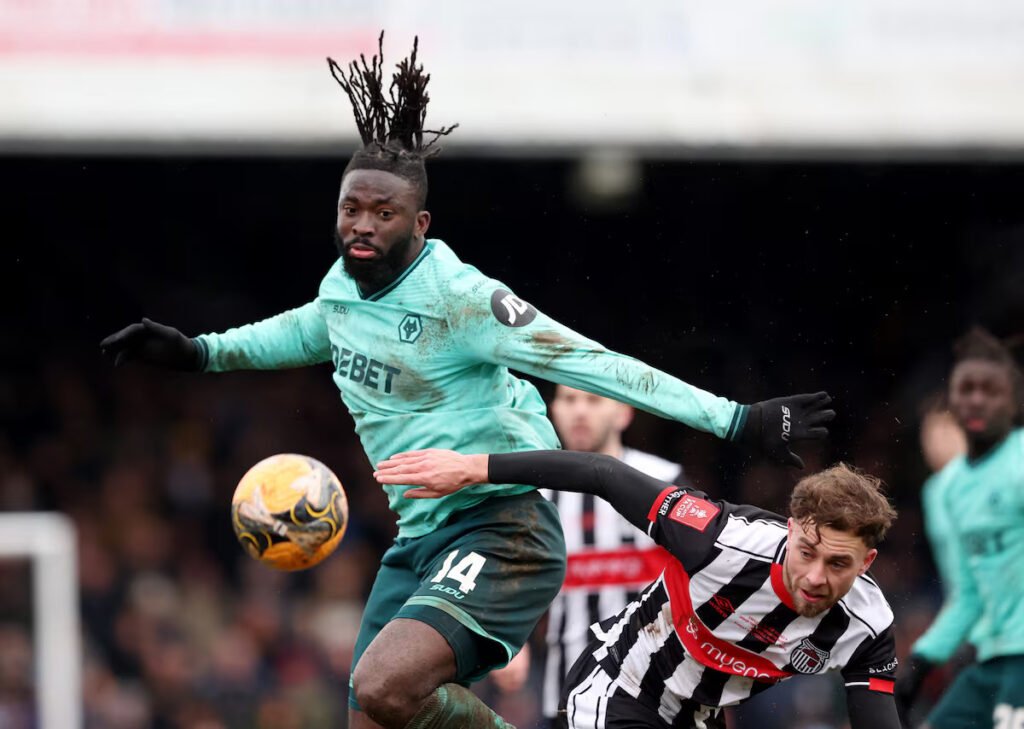 Wolves’ Tolu Arokodare in action with Grimsby Town's Jamie Walker