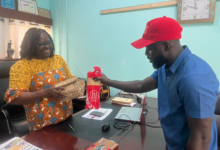• Mr Isaac Dadzie handling a package to Mrs Georgina Naa Maku Quaittoo, Editor of The Spectator