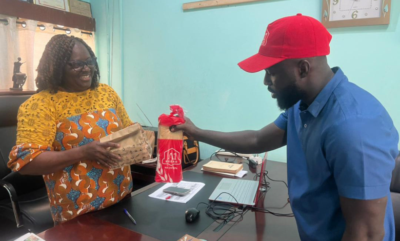 • Mr Isaac Dadzie handling a package to Mrs Georgina Naa Maku Quaittoo, Editor of The Spectator