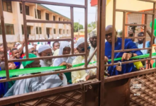 : Alhaji Tikumah being assisted by other dignitar ies to cut the tape to formally open the facility