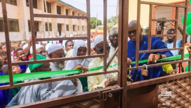 : Alhaji Tikumah being assisted by other dignitar ies to cut the tape to formally open the facility