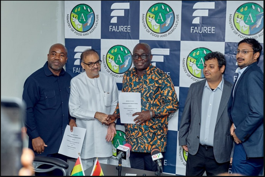 Mr Sib Ali, (second from left), Fauree Link Ghana Limited Board Chairman, exchanging the Agreement document with Mr Eric Opoku (middle), Minister of Food and Agriculture