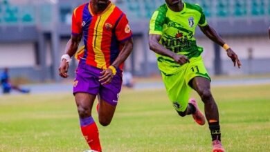 • Heart's Martin Karikari in a tussle for the ball with Emmanuel Abban (in green)