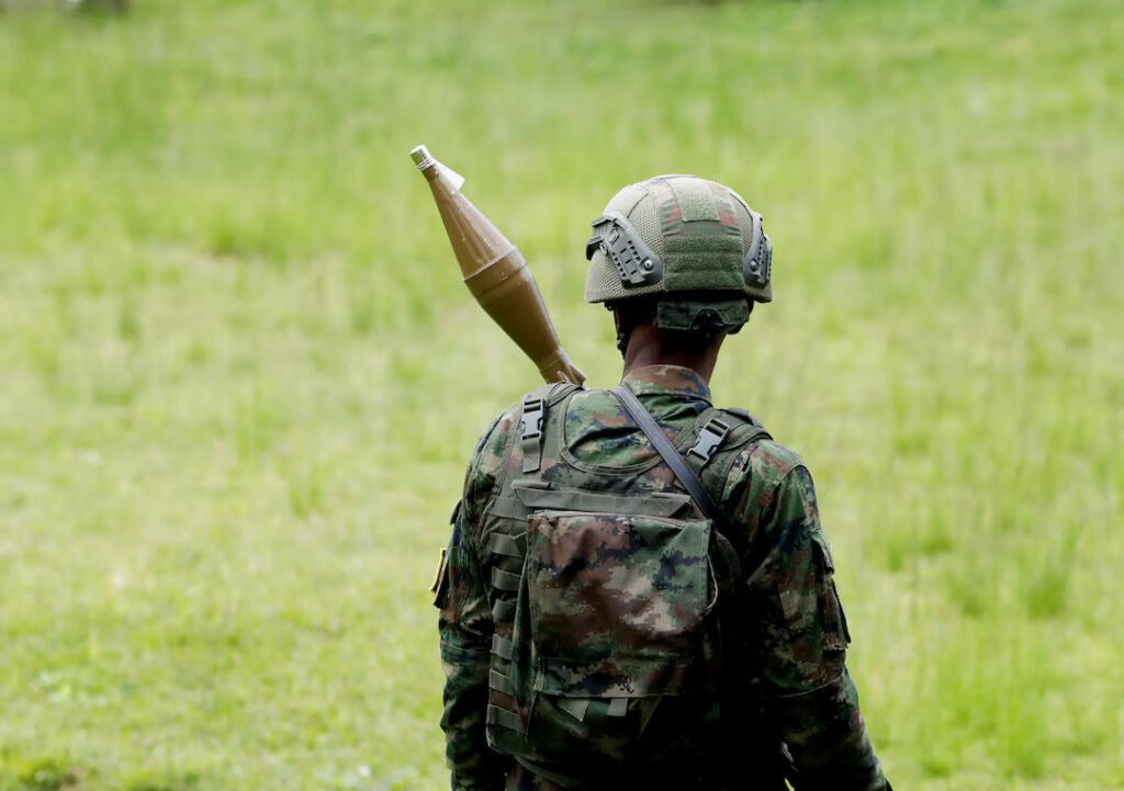 A Rwanda Defence Force (RDF) soldier stands in position at the Grande Barrier border