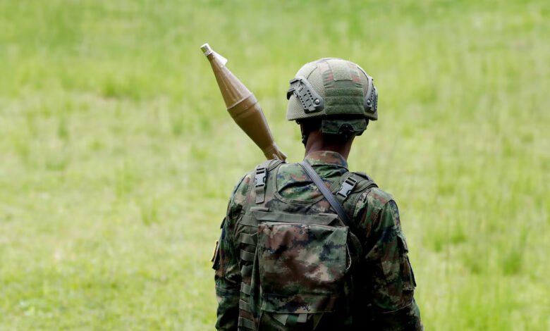 A Rwanda Defence Force (RDF) soldier stands in position at the Grande Barrier border
