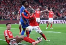 (FILES) Real Madrid's Brazilian forward #07 Vinicius Junior fights for the ball with SL Benfica's Argentine forward #25 Gianluca Prestianni during the UEFA Champions League knockout round play-off first leg football match between SL Benfica and Real Madrid CF at Estadio da Luz in Lisbon on February 17, 2026. UEFA on February 23, 2026 suspended midfielder Gialuca Prestianni from Benfica's Champions League play-off second leg against Real Madrid this week after he was accused of racially abusing Vinicius Junior. (Photo by PATRICIA DE MELO MOREIRA / AFP)