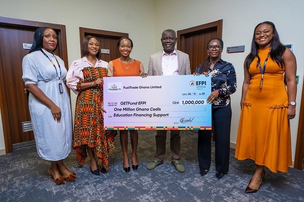 Ms. Christabel Sewornu (second from right) presenting the dummy cheque to Mr Adjei (fourth from left)