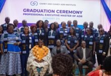 Justice Mensah-Homiah (seated middle) with Mr Gamey (left), Dr Seddoh (right) and the graduands