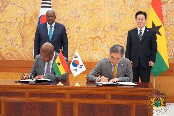 Mr Ablakwa (seated left) and his counterpart signing the Agreement, whilst President Mahama and President Lee Jae Myung looks on