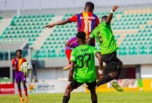 Hearts' Karikari (11) in an aerial tussle with two defenders of Basake Holy Stars