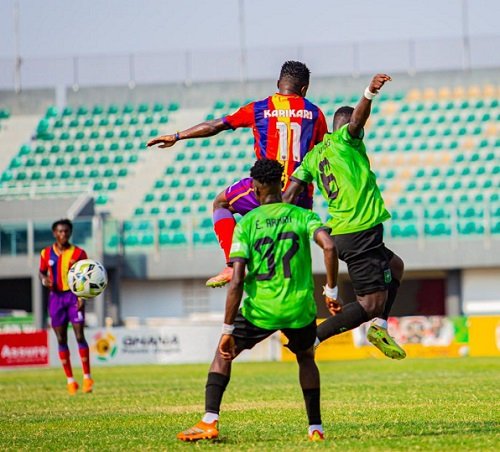 Hearts' Karikari (11) in an aerial tussle with two defenders of Basake Holy Stars