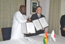 Mr Yoshimoto (right) and Mr Alhassan exchanging the grant document Photo Victor A. Buxton
