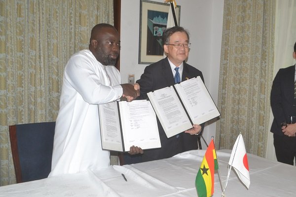 Mr Yoshimoto (right) and Mr Alhassan exchanging the grant document Photo Victor A. Buxton