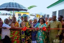 Mrs Mahama (second from right) being assisted by other dignitaries to cut the tape to inaugurate the facility
