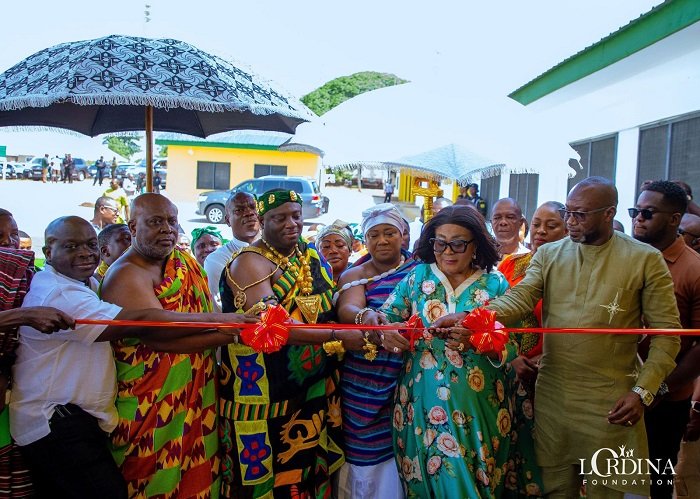 Mrs Mahama (second from right) being assisted by other dignitaries to cut the tape to inaugurate the facility