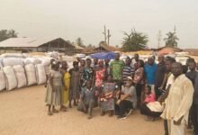 Mr Mould (squatting, second from right) with farmers of one of the communities