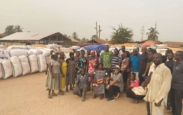 Mr Mould (squatting, second from right) with farmers of one of the communities