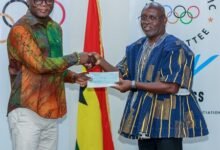 Mr Kofi Adams (left) receives a cheque from the GOC President, Richard Akpokavie