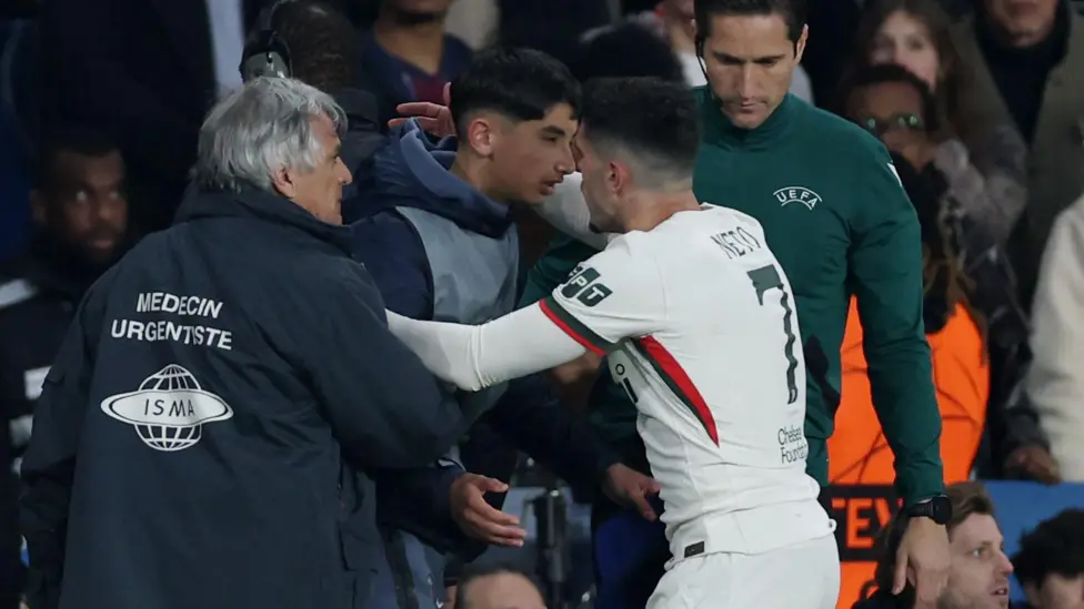 Pedro Neto embraces a PSG ball boy in the aftermath of shoving him during their Champions