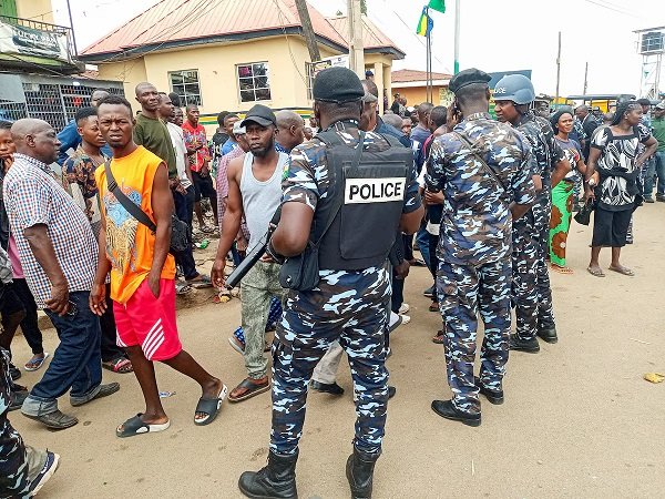 • People gather as policemen arrive at the scene of the attack in Angwan Rukuba, Jos North, Plateau State