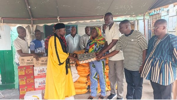 Alhaji Leetei Mensah (left) receiving some of the items from Mr Anyetei (third from right) and Ms Sowah (second from left)