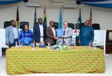 Dr Brooks (third right) exchanging the signed MoU with Mr Drabiuk