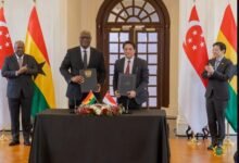CEO of GIPC, Mr Madjie (middle), and CEO of Singapore Cooperation Enterprise, Mr Wy Mun Kong, displaying the signed MoU documents during the Singapore visit of President John Dramani Mahama