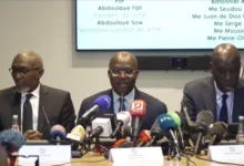 Senegalese Football Federation president Abdoulaye Fall (centre) and his legal team conducted a confrontational media conference in Paris