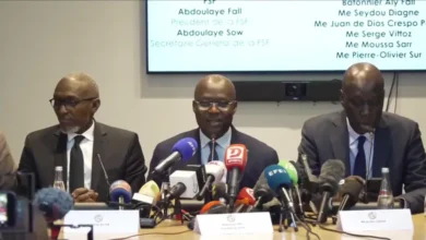 Senegalese Football Federation president Abdoulaye Fall (centre) and his legal team conducted a confrontational media conference in Paris