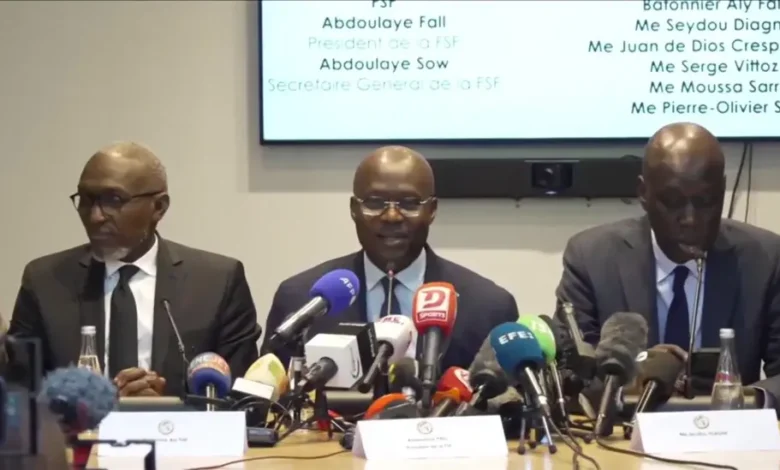 Senegalese Football Federation president Abdoulaye Fall (centre) and his legal team conducted a confrontational media conference in Paris