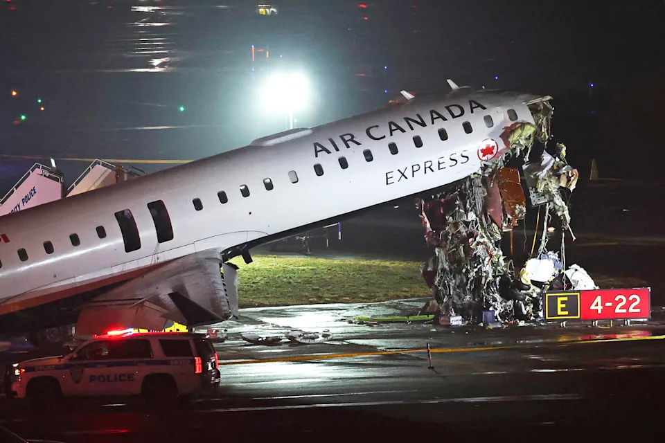 • The Air Canada Express CRJ-900 sits on the runway after colliding with a Port Authority re truck at LaGuardia Airport in New York yesterday