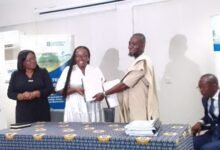 -Prof Amfo (left) exchanging the MOU with Mr Razak