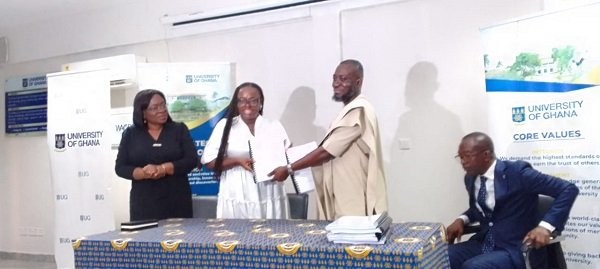 -Prof Amfo (left) exchanging the MOU with Mr Razak