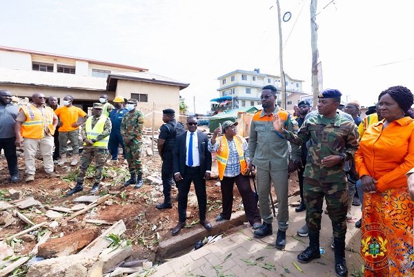 Vice President Naana Jane Opoku-Agyemang (right) being briefed during her visit to the Accra New Town collapse site