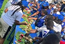 Former and current students of Wesley Grammar eating together during the celebration