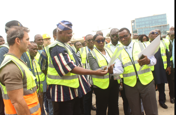 Ms Yvonne Nana Afriyie Opare (third from right) showing Mr Joseph Nikpe Bukari (in smock) the new phototype outlook of the Terminal 2 Departure Hall. Photo. Ebo Gorman.JPG