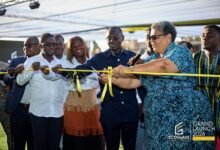 Mrs Tetteh-Agbotui (right) being assisted by other dignitaries to cut the tape for the opening of the facility