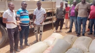 The suspects with some of the cocoa bags