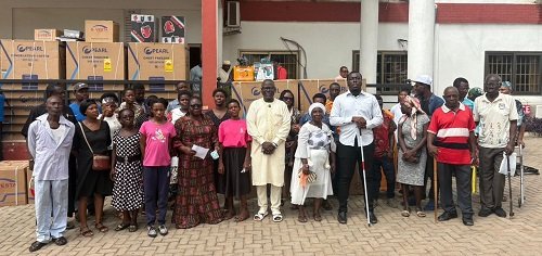 Alhaji Faila ( Middle) with the beneficiaries and their items