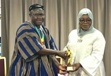 Ms Shamima Muslim receiving an award on behalf of Mr Felix Ofosu Kwakye