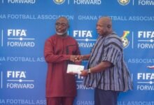 Chairman of the Greater Accra RFA Mr Samuel Aboabire (right) receives documents to the vehicle from the General Secretary of the GFA Mr Prosper Harrison Addo