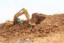 An earth moving machine working on the ongoing Afienya-Dodowa road project