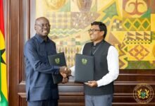 Dr Forson (right) exchanging the signed agreement with Mr Gulla