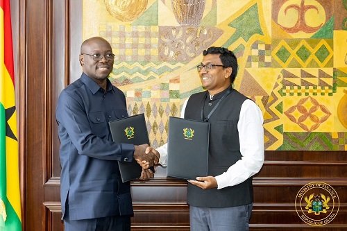 Dr Forson (right) exchanging the signed agreement with Mr Gulla