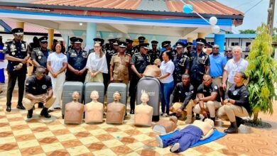 Mr Yohuno ( standing, sixth from right ) receiving the donated items