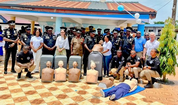 Mr Yohuno ( standing, sixth from right ) receiving the donated items