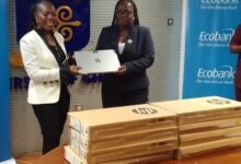 Mrs Osei-Poku (left) presenting the laptops to Prof Amfo