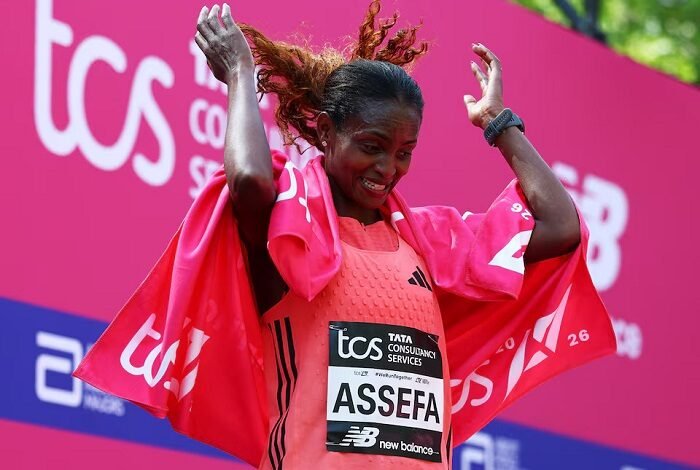 Ethiopia's Tigst Assefa celebrates after winning the women's elite race